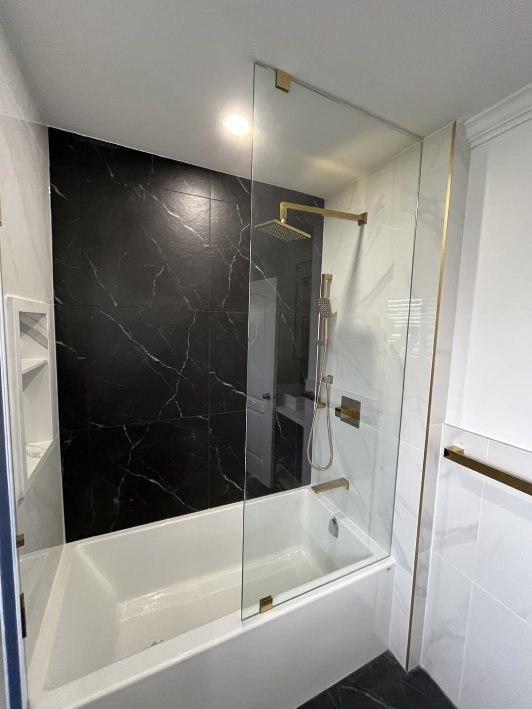 Bold Black Marble Bathroom with Gold Fixtures — image 1