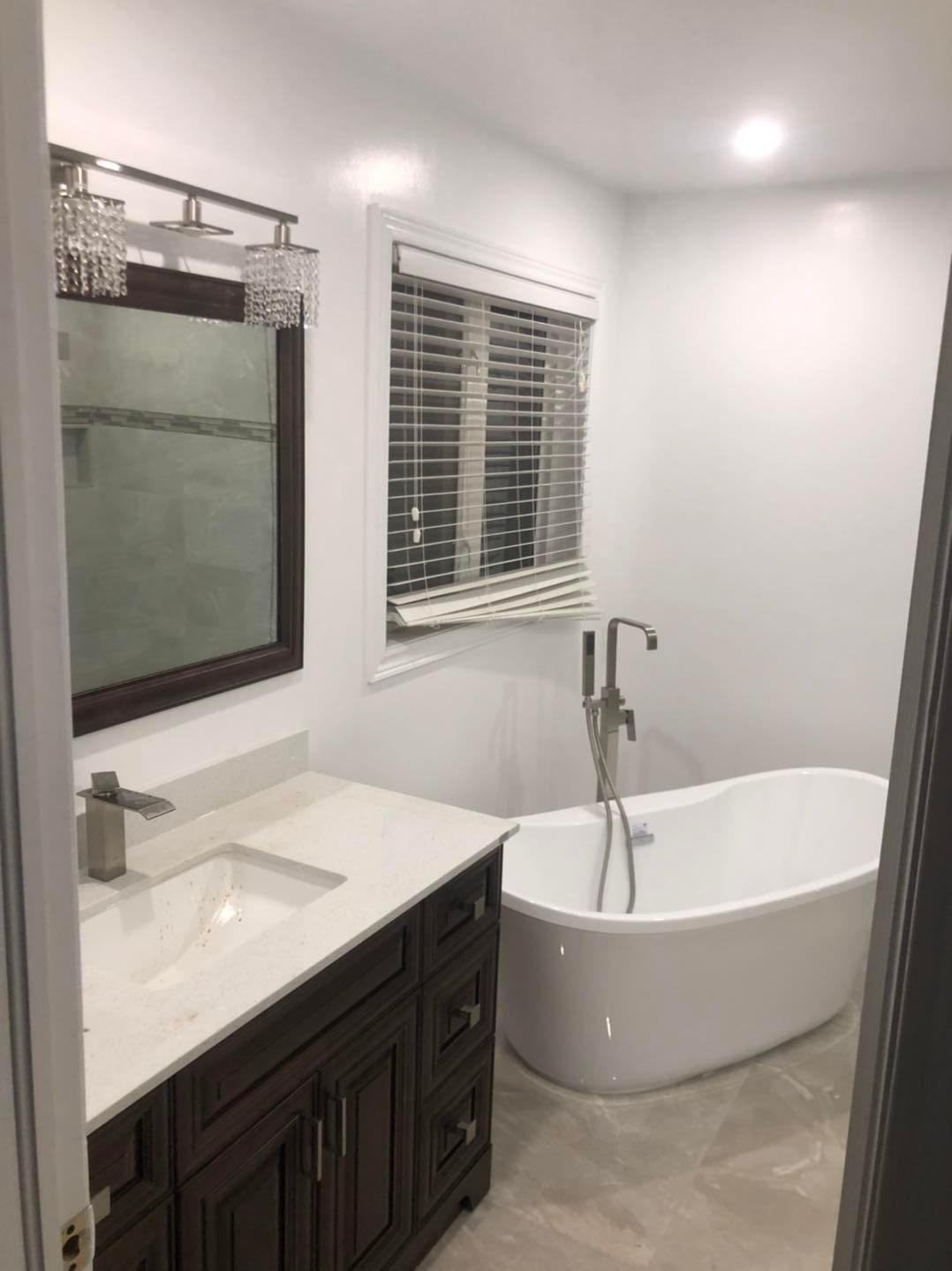 Classic Ensuite with Soaker Tub and Dark Wood Vanity — image 1